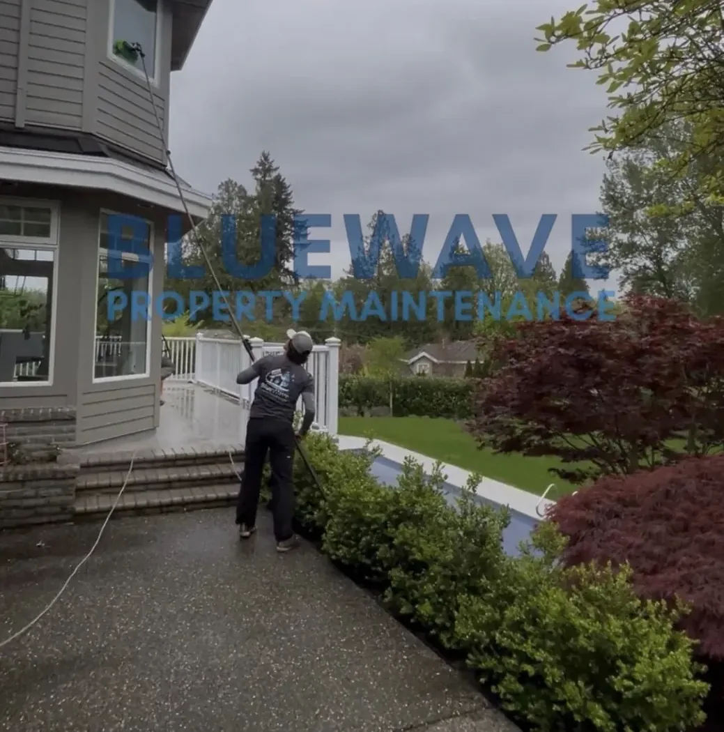 BlueWave technician cleaning a window at a Metro Vancouver property